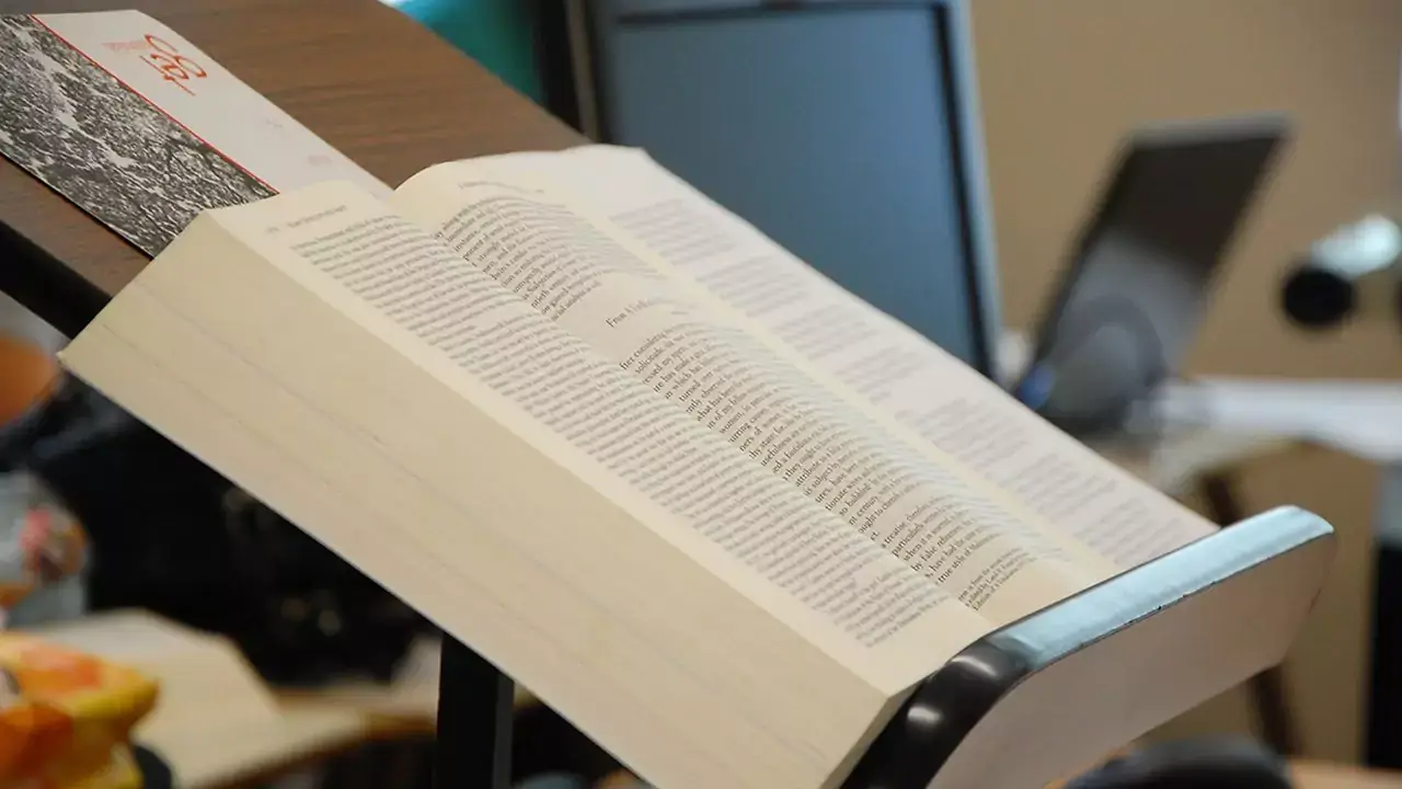 A large book on a wooden stand